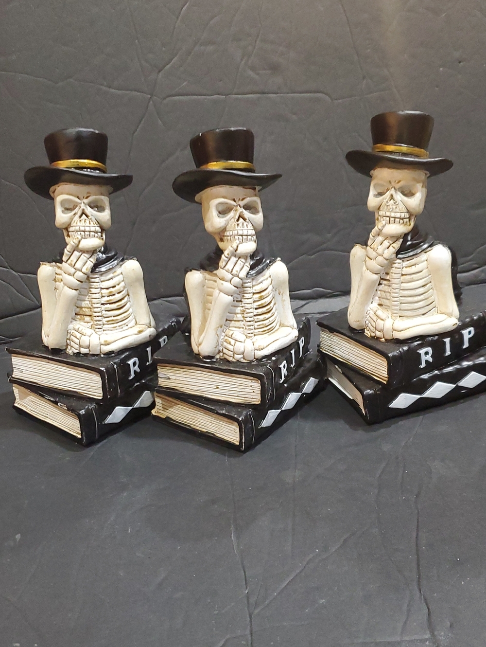 3pack top hat wearing thinking Skeleton atop stacked ancient RIP books brand new